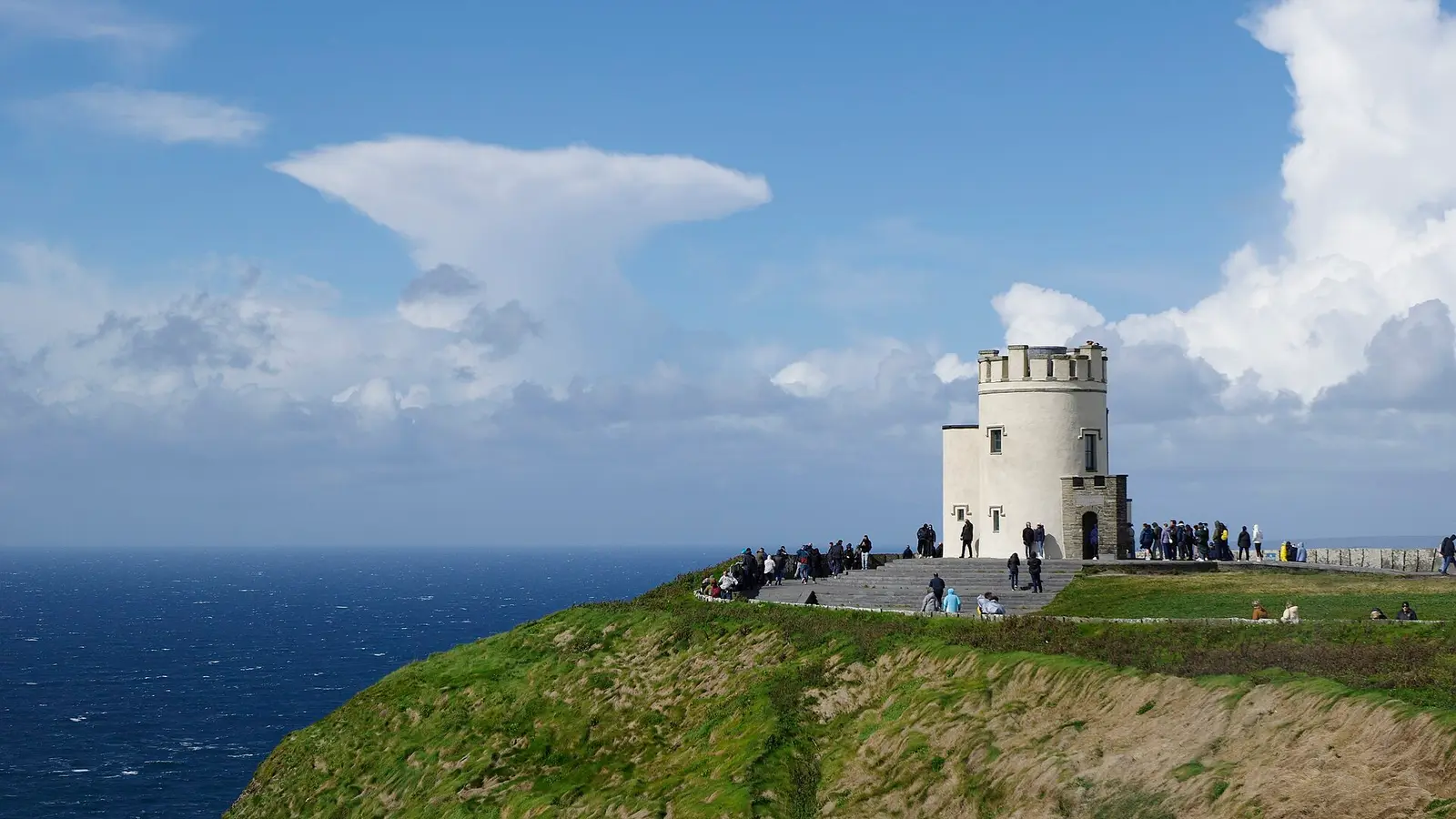 O'Brien's Tower on the edge of the Cliffs of Moher under a blue sky