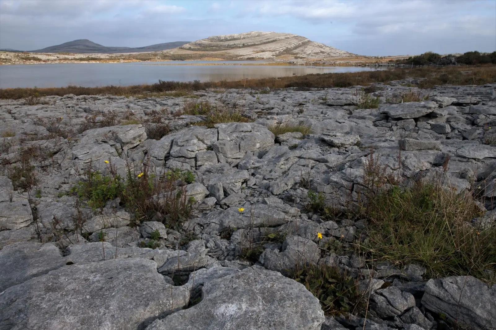 Burren limestone pavement above Lough Gealáin, with Mullach Mór behind